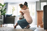 woman hugs child in living room
