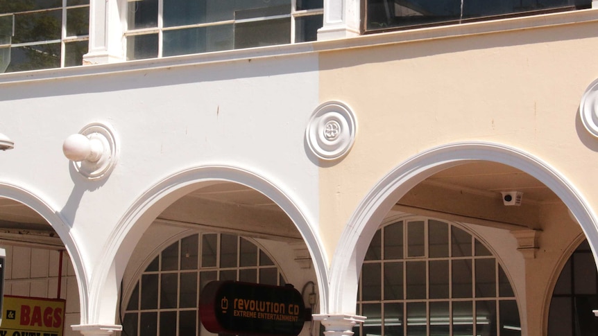 A building with arches with different coloured paint.