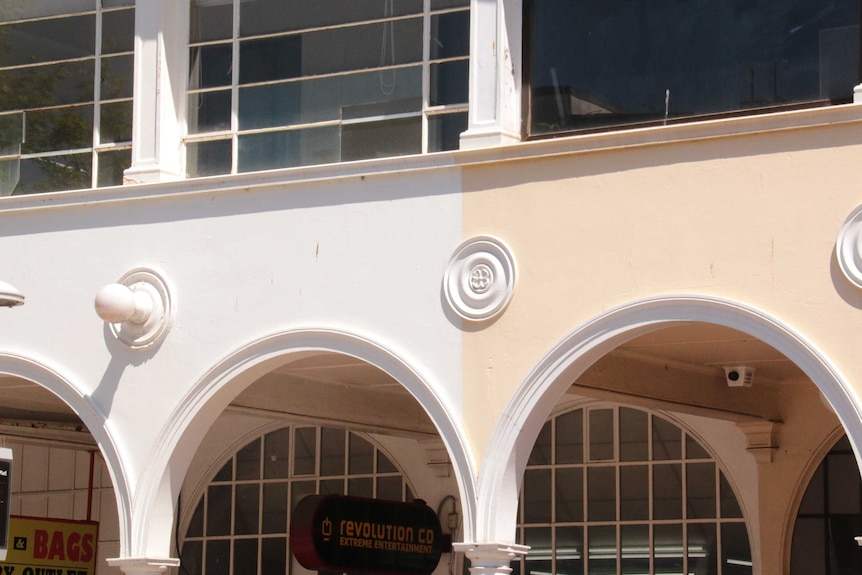 A building with arches with different coloured paint.