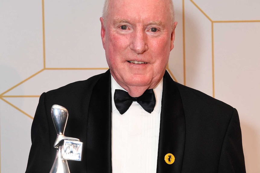 Home and Away star Ray Meagher poses with his Logie award.