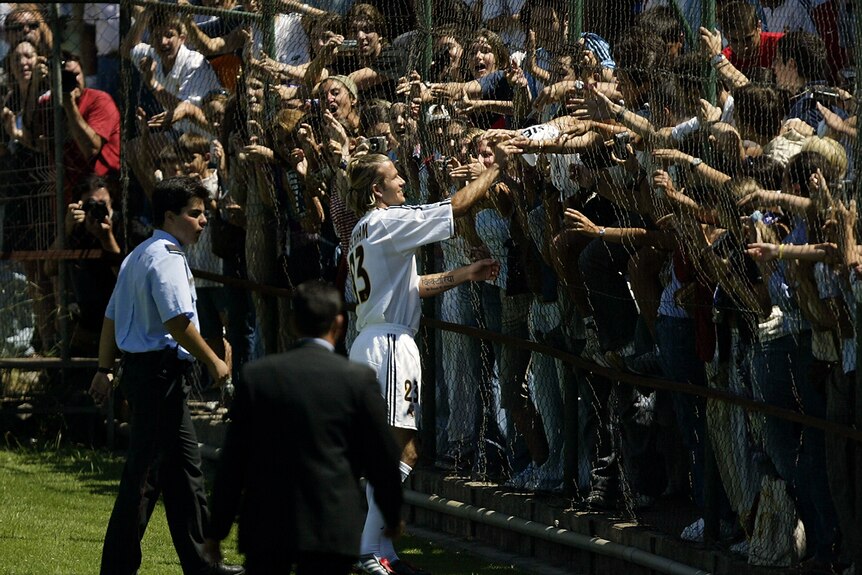 Fans crowd around David Beckham