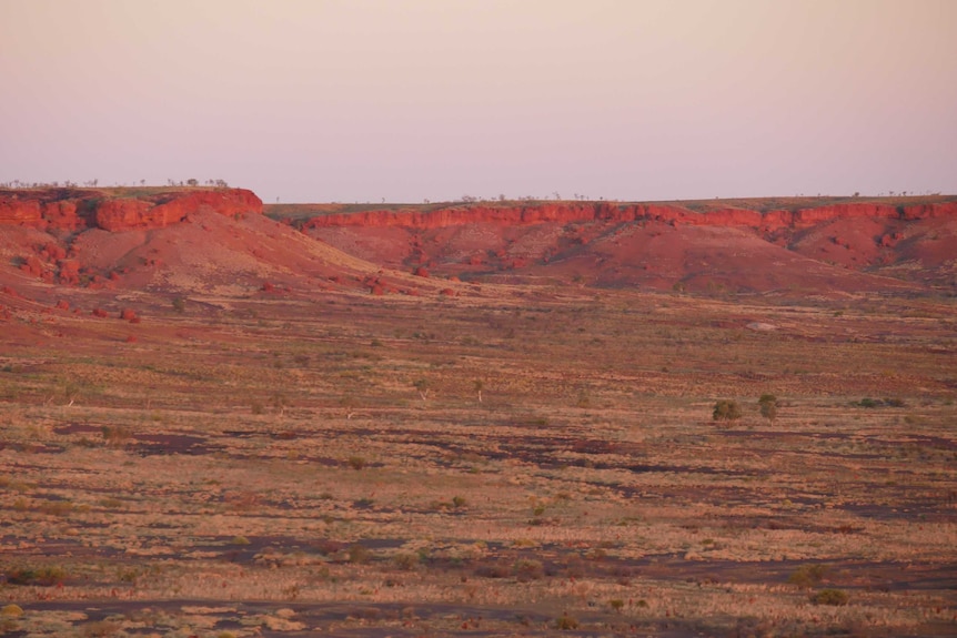 The red cliffs in the Australian desert at sunset.
