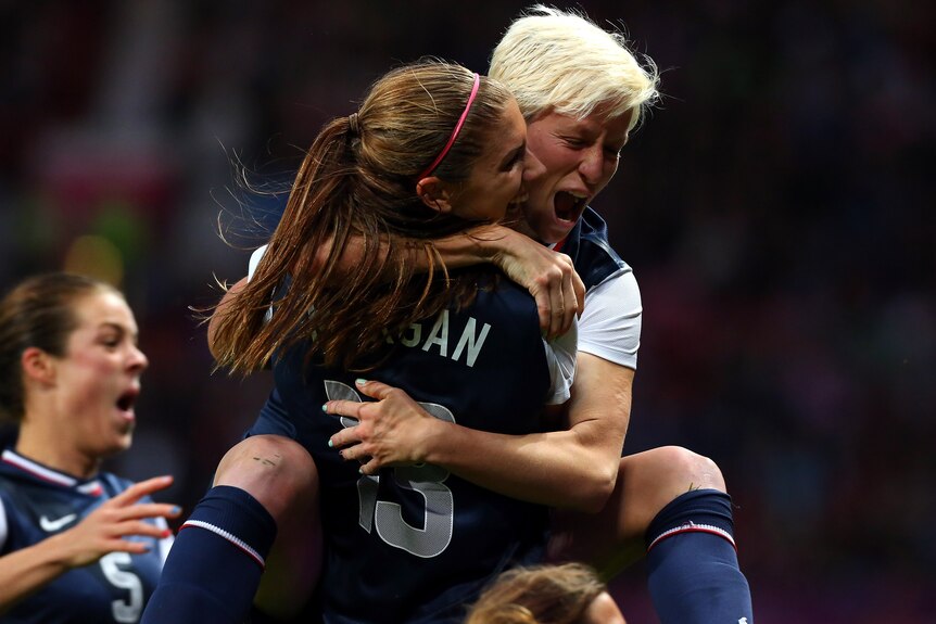 USA's Megan Rapinoe celebrates with goal-scorer Alex Morgan after Morgan's late goal to beat Canada.