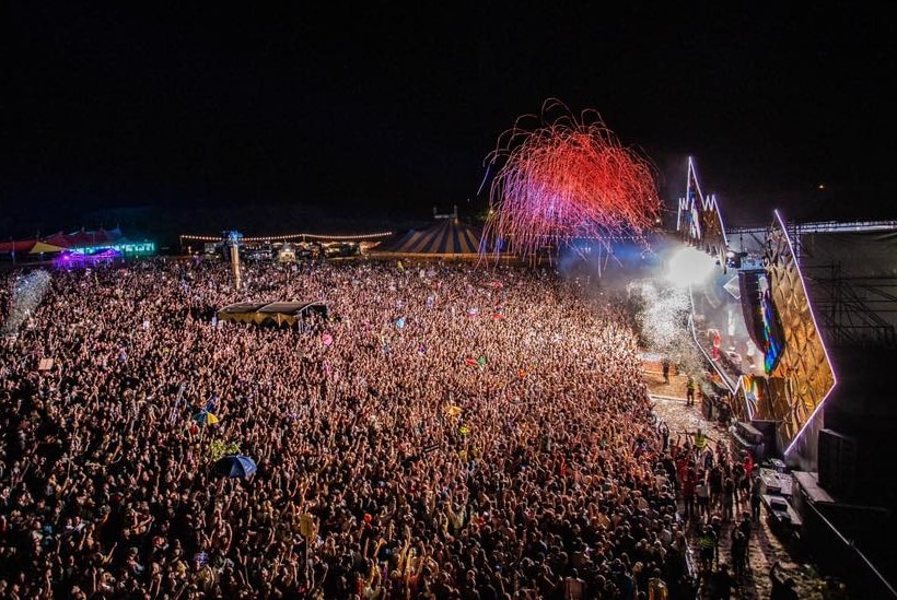 A large crowd watches a light show on stage at Beyond The Valley festival.