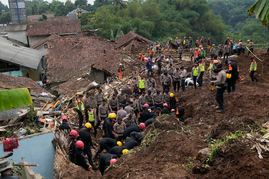 Rescuers search for victims in a village hit by an earthquake-triggered landslide.