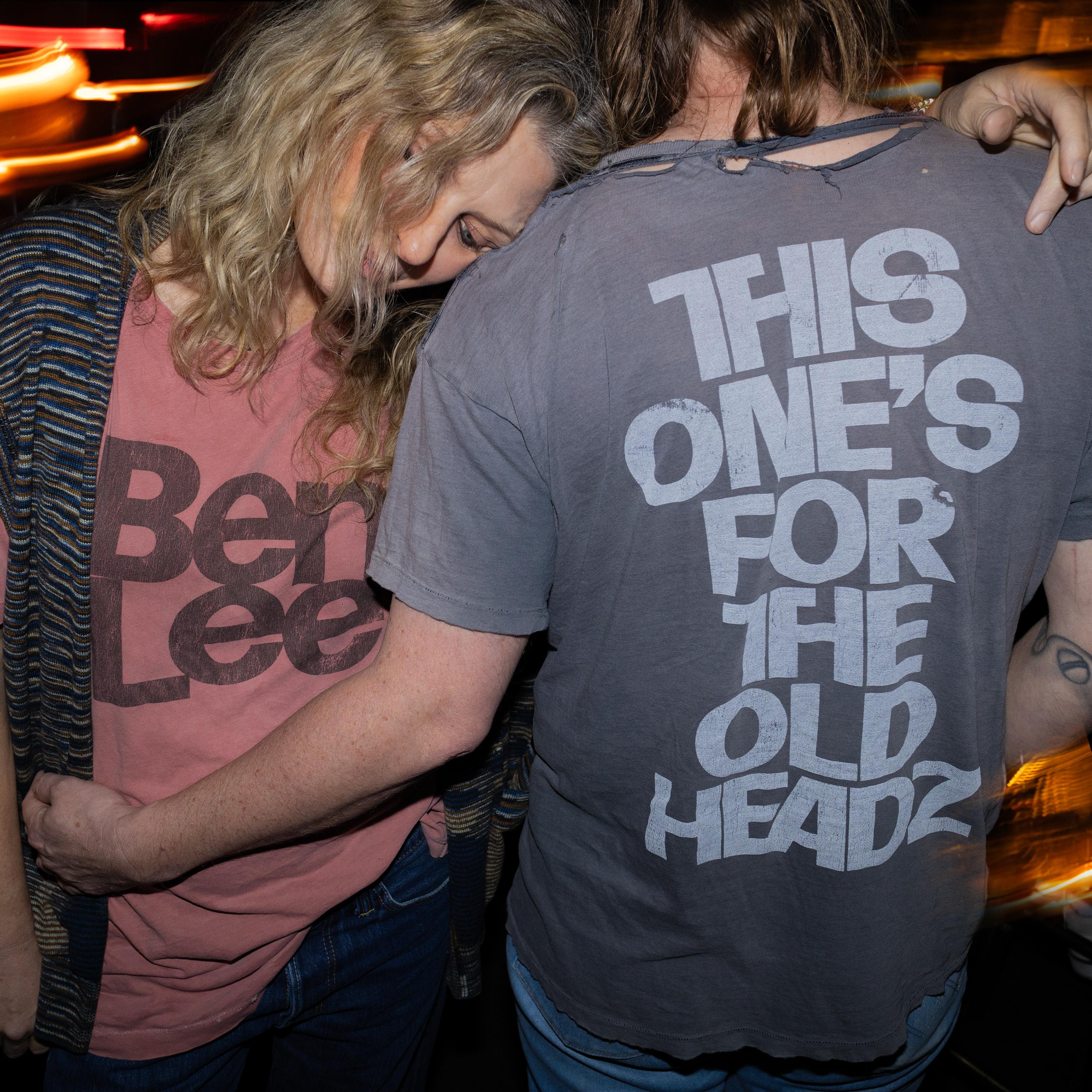 A hip male-female couple wearing ripped t-shirts repsectively reading: Ben Lee, This One's For the Old Headz