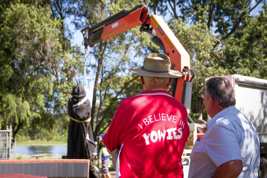Onlookers watch the new yowie being installed.
