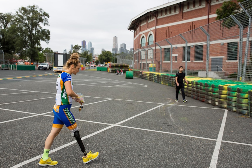 Macdougall walks while eating a snack before gym at the Victorian Institute of Sport in Albert Park.
