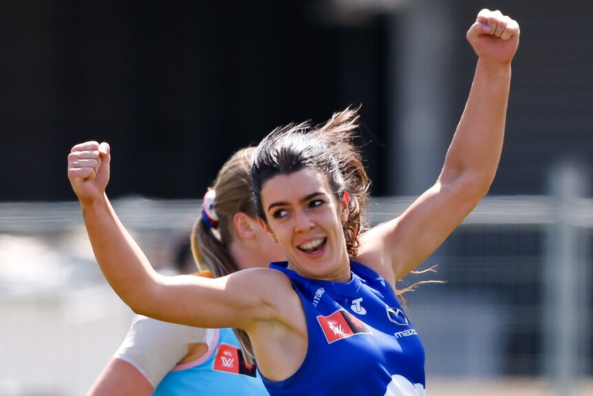 A Kangaroos AFLW player celebrates a goal against Western Bulldogs.