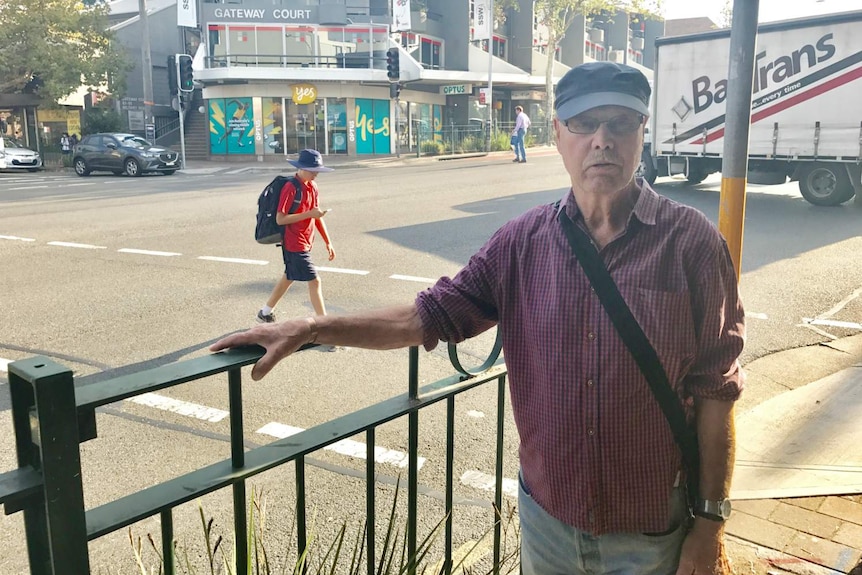 A man standing outside an Optus store