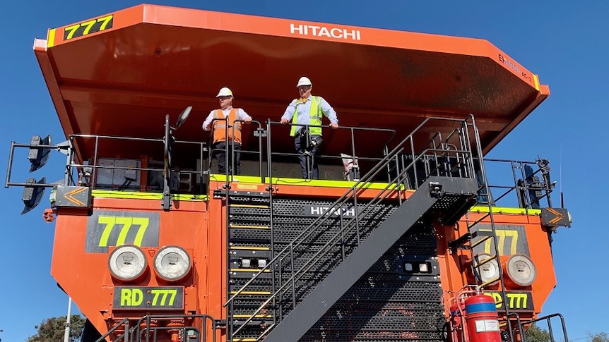 Deputy premier John Barilaro and Hunter MP Michael Johnsen standing on a massive coal truck