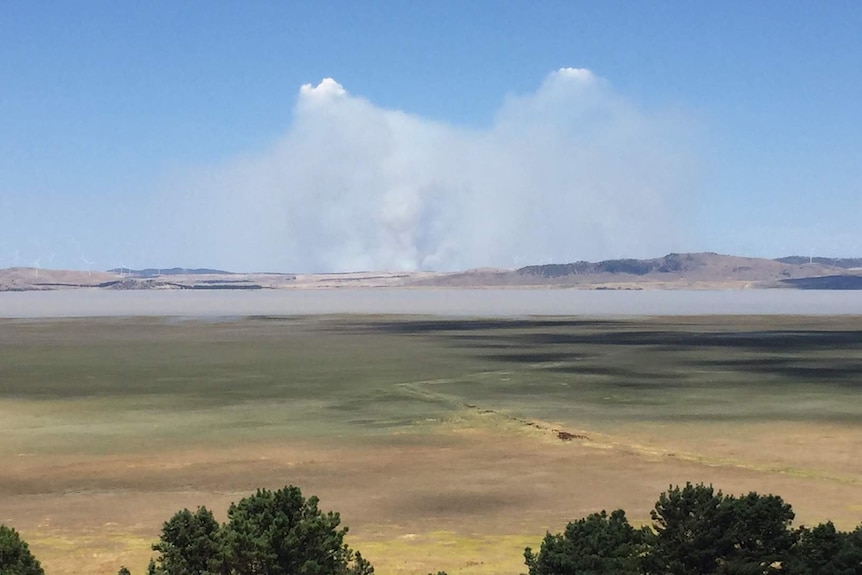 Smoke rises above Lake George.