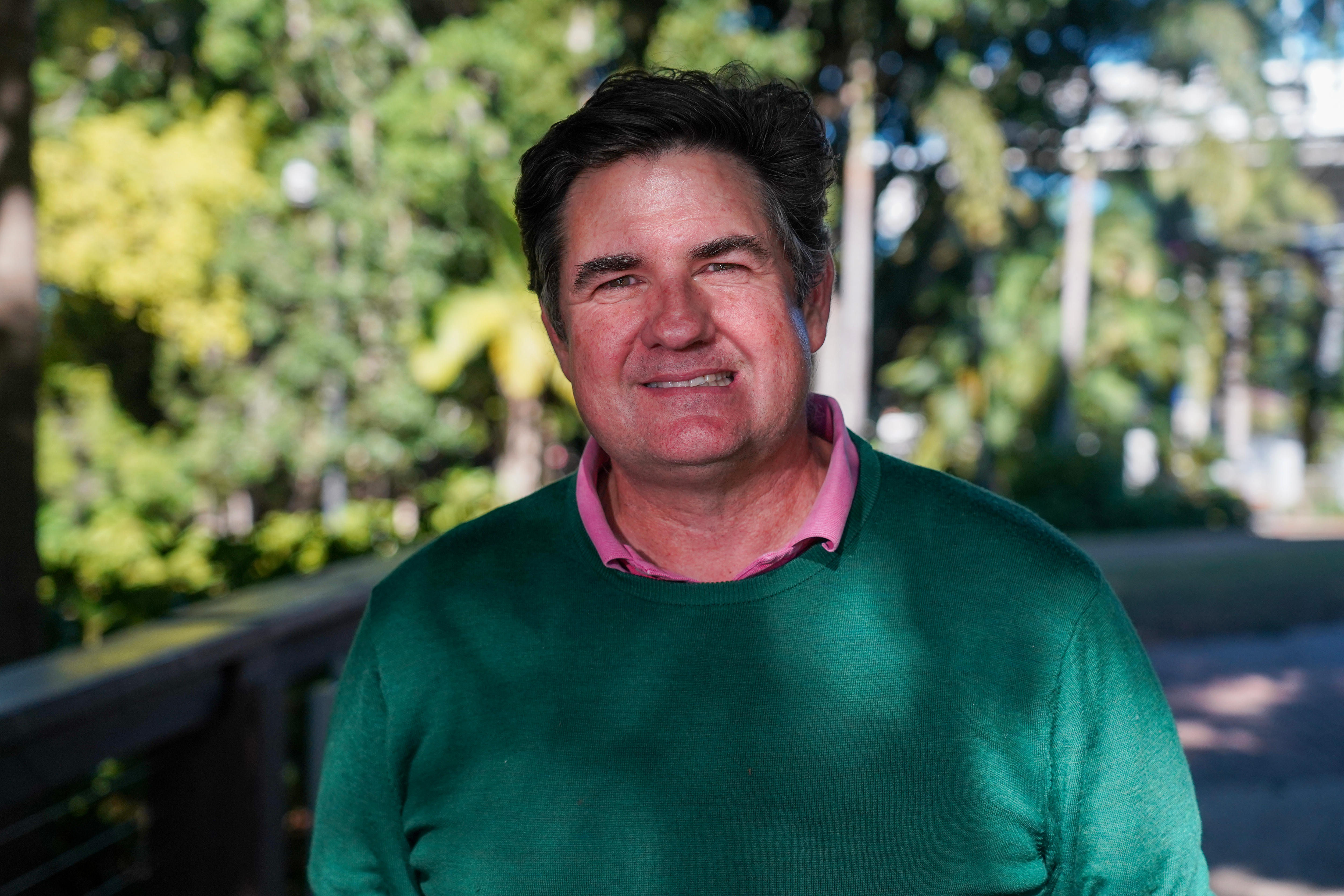 Man in green jumper with pink shirt