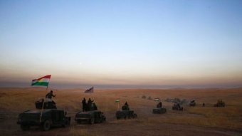 Kurdish convoy crosses the desert in Iraq.
