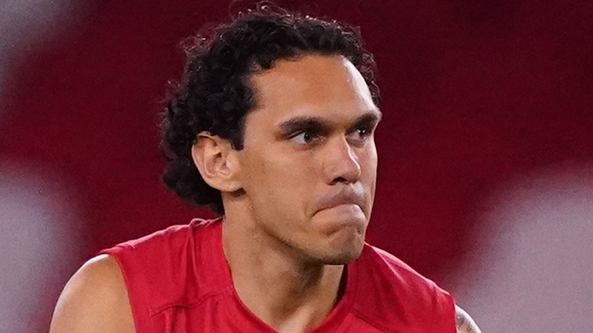 Harley Bennell prepares to kick a football during an AFL game.