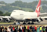 A crowd watches the Qantas 747 VH-OJA land at Albion Park airport.