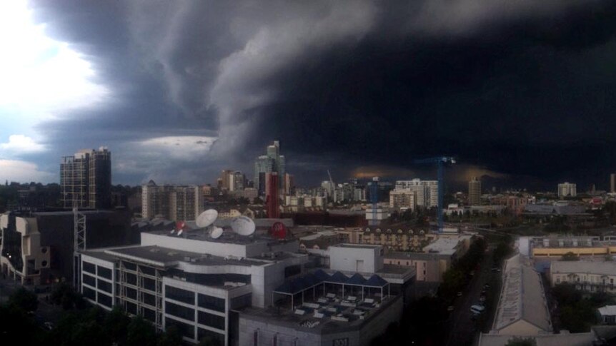 A large storm cloud sweeps across Melbourne.