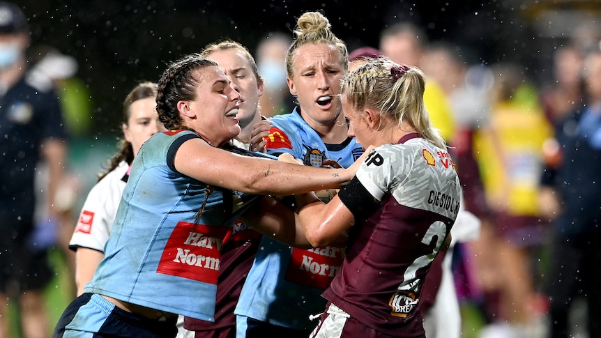 A group of rugby league players engage in a scuffle during a match