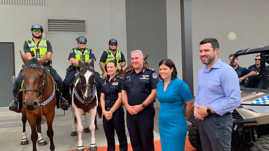 Group of politicians, police on foot and police on horse at an announcement