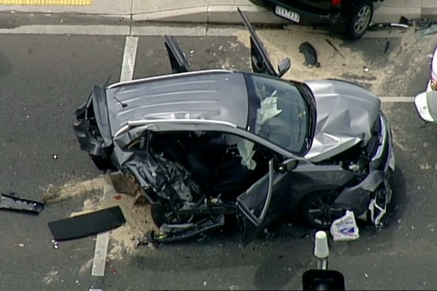 A crumpled black car after a car crash.