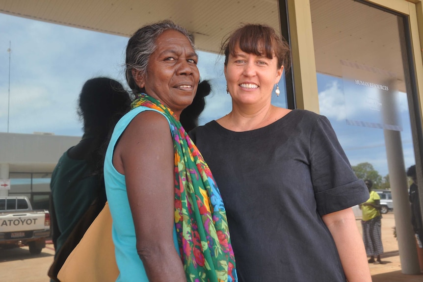 Two women standing outside a clinic