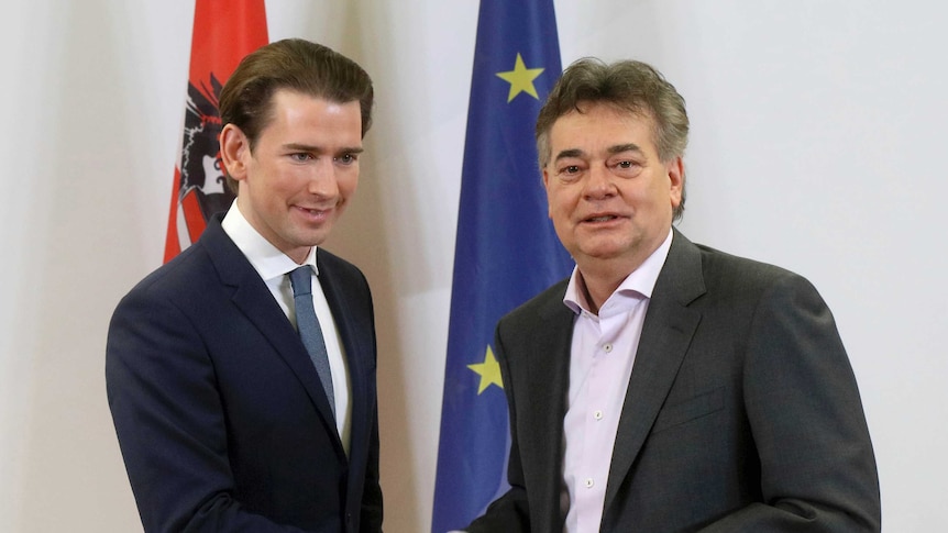Sebastian Kurz shakes hands with Werner Kogler in front of the Austrian and EU flags.