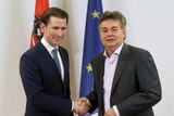 Sebastian Kurz shakes hands with Werner Kogler in front of the Austrian and EU flags.