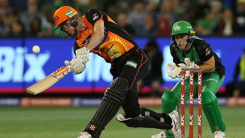 A batsman steps down the wicket and hits the ball in Twenty20 as the wicketkeeper watches on.