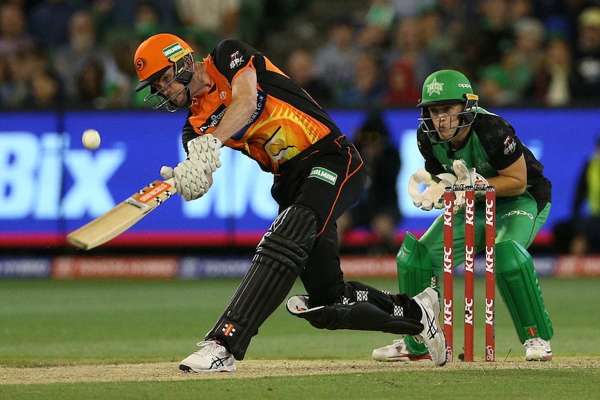 A batsman steps down the wicket and hits the ball in Twenty20 as the wicketkeeper watches on.