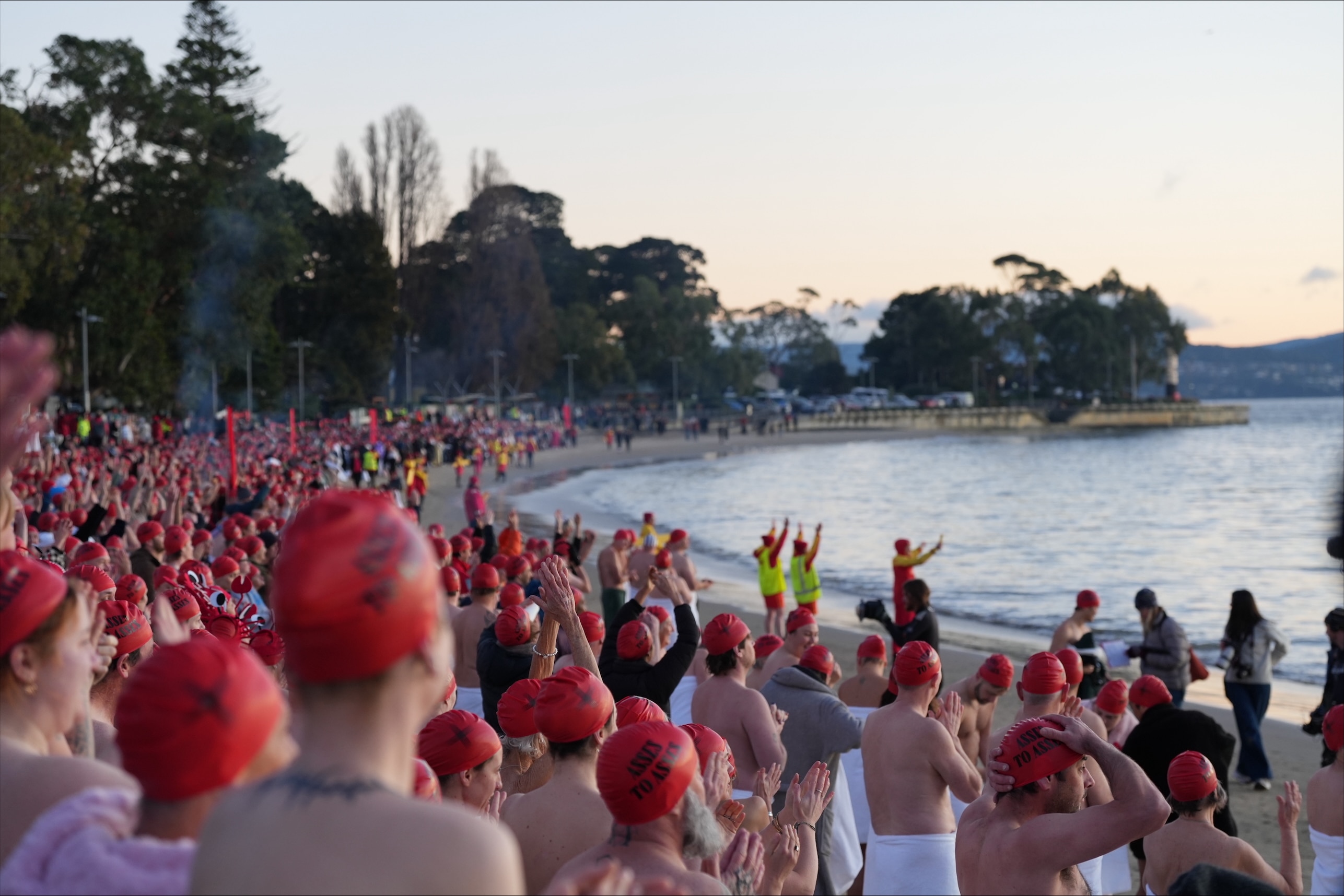 Nude swimmers take chilly plunge in Dark Mofo solstice swim