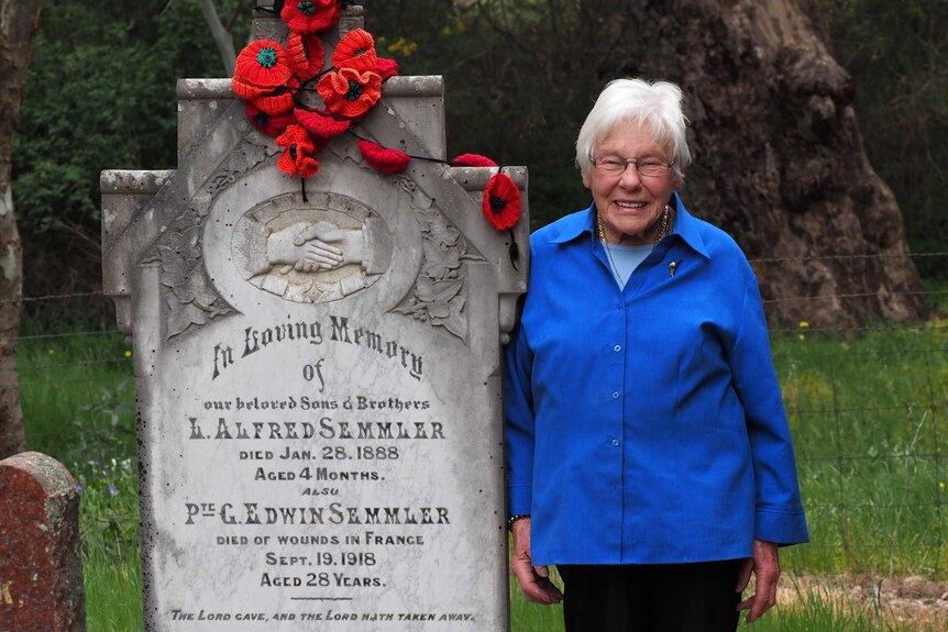 Merle Hoffmann stands next to the memorial of her uncle Edwin Semmler.