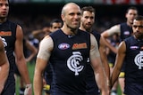 Chris Judd leads his players from the field