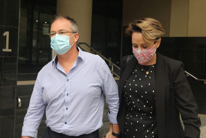Michael Maxwell and Sharon Hoysted leave court holding hands.