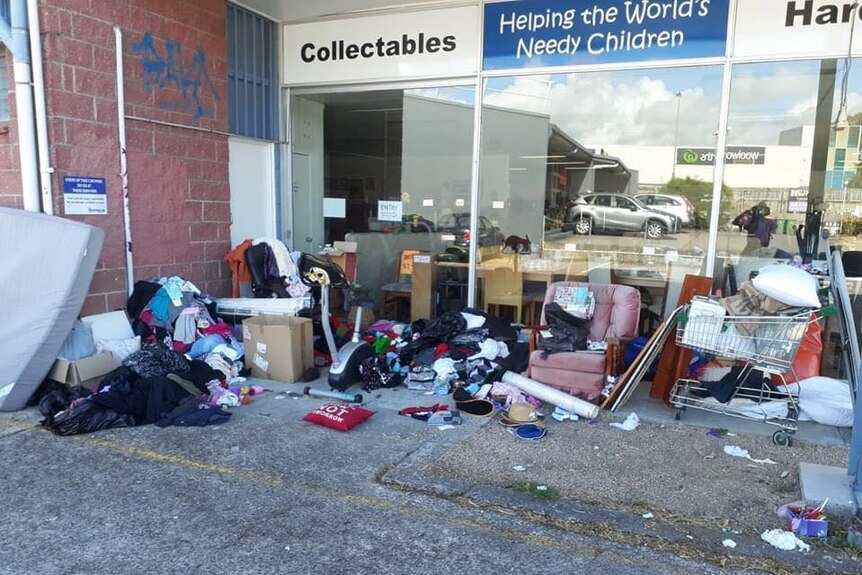 A pile of clothes and household goods outside a charity shop