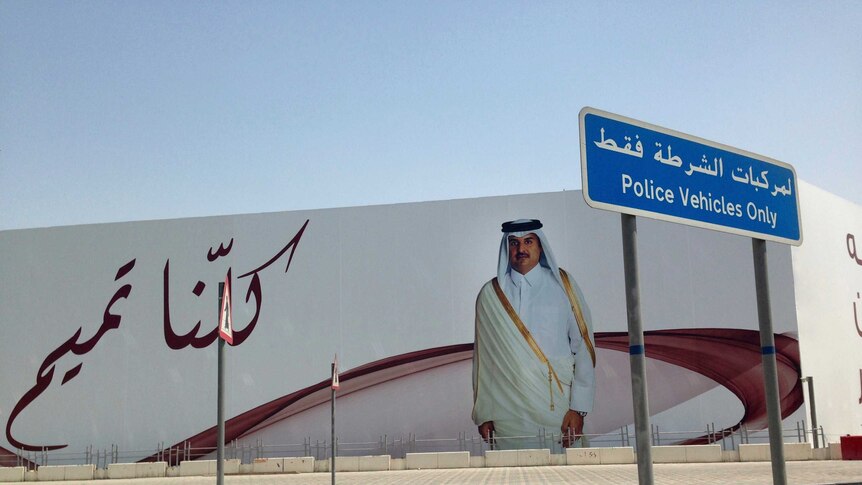 A billboard with Qatar's Emir Sheikh Tamim bin Hamad Al Thani in front of the words "We are all Tamim"