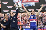 Western Bulldogs' Robert Murphy (C) and Easton Wood (R) hold the cup after AFL grand final win.