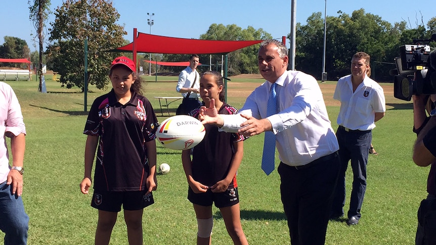 NT Chief Minister Adam Giles throws a rugby ball
