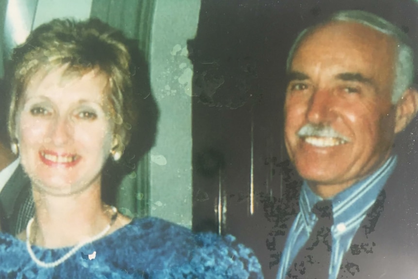 a head shot of a woman and a man dressed up in nice clothes, smiling at the camera