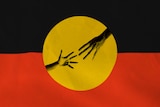 The Aboriginal flag with two hands reaching for each other in the yellow centre.