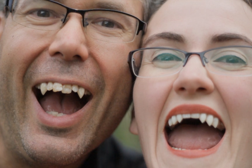 Jarrad and Megan Smith wear their prosthetic fangs