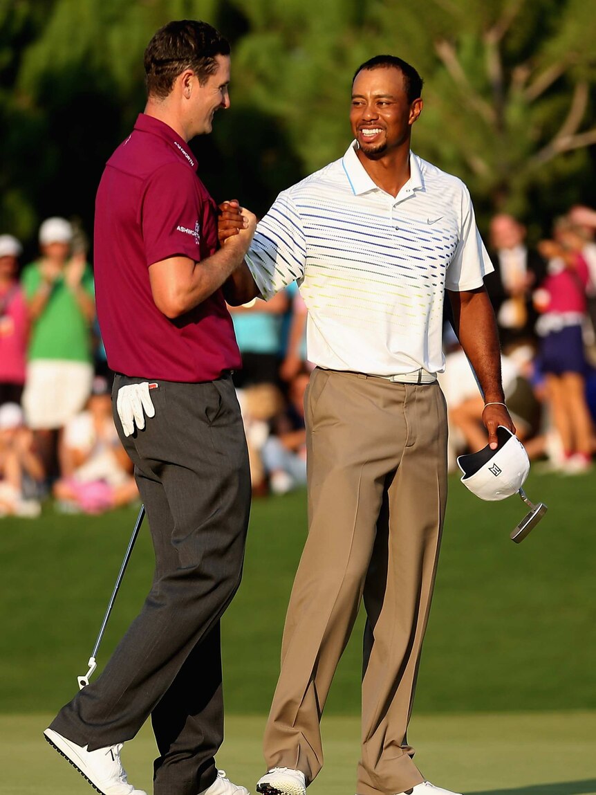 Through to the final ... Justin Rose is congratulated by Tiger Woods.
