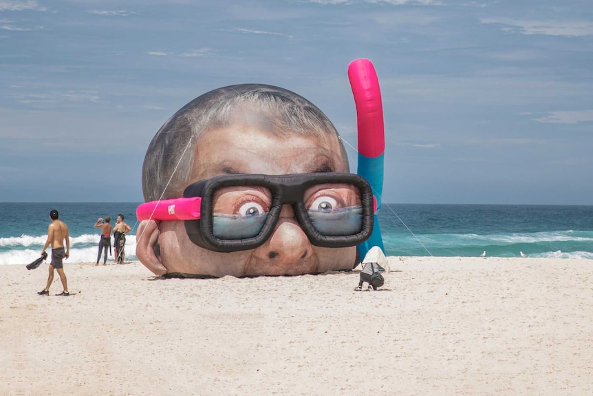 Sculpture “Damien Hirst Looking for Sharks” features the snorkelling head of UK artist Damien Hirst.