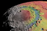 A crater on the moon's rocky, textured surface