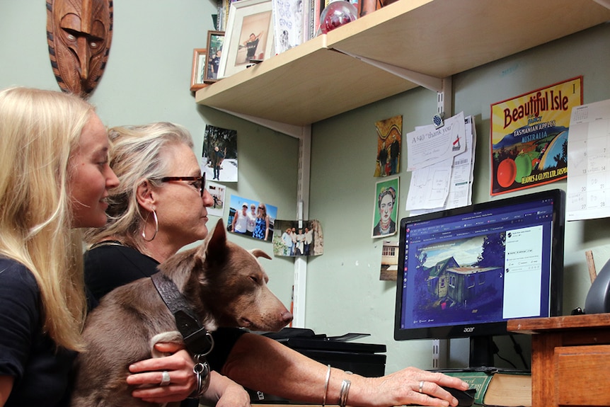 Kayla Roberts and mother look at a computer