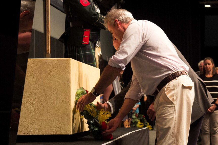 Tim and Chris Scott lay a wreath during a Last Post ceremony