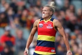 An Adelaide Crows AFLW player celebrates kicking a goal against Melbourne.