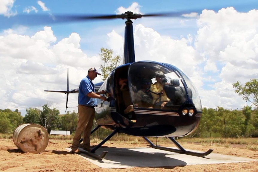 Haydn Sale, from the Yougawalla Pastoral Company, prepares his helicopter at Margaret River Station.