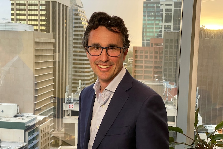 Rio Tinto's chief executive for iron ore, Simon Trott, in front of Perth skyline.