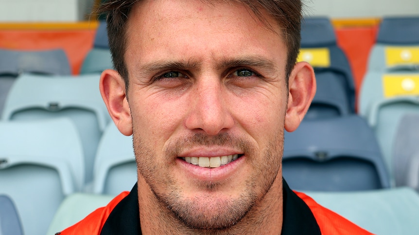 A tight head shot of a smiling Mitch Marsh sitting in the WACA Ground stands.