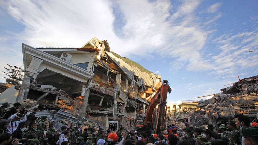 Rescue workers look for survivors inside Padang hotel